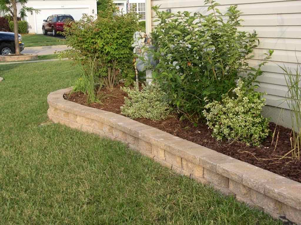 Brick edging garden bed border along a home's foundation