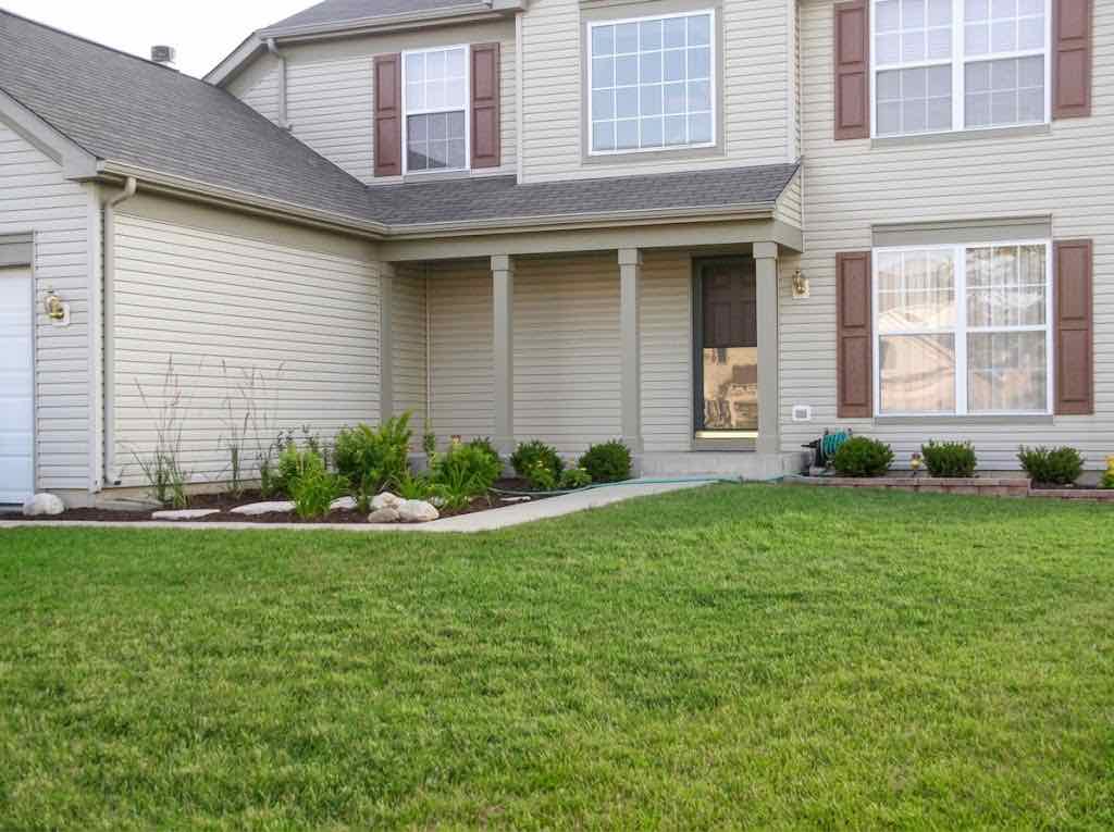 Curved brick edging along a front lawn and walkway