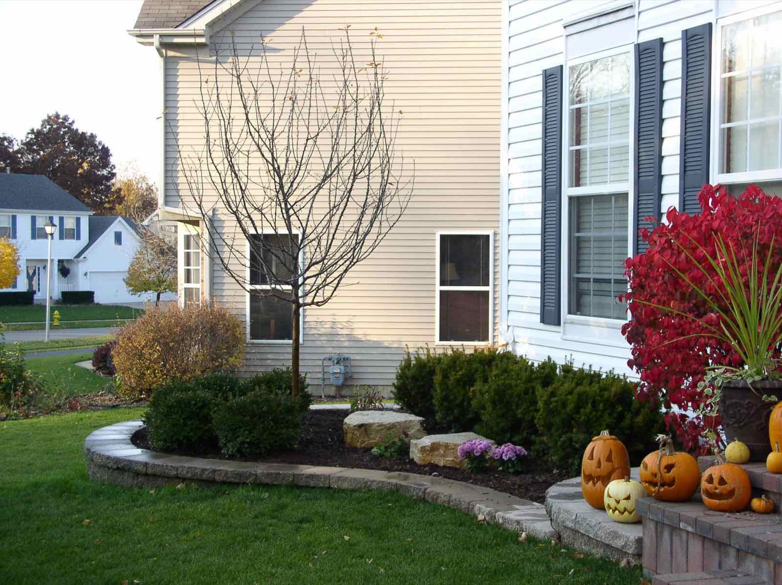 Curved brick edging around a front yard garden bed