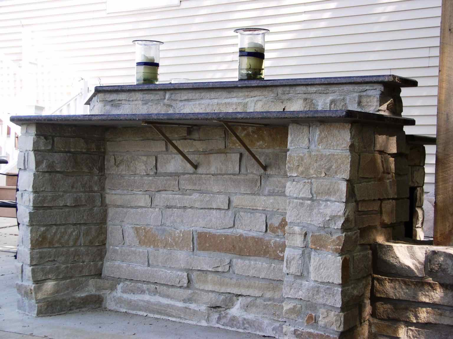 Stone outdoor bar with granite countertop