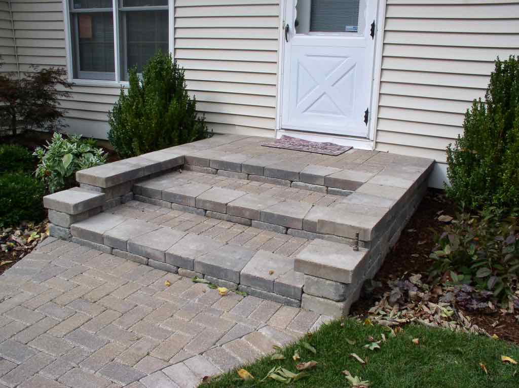 Paver steps and walkway leading to a side entry door