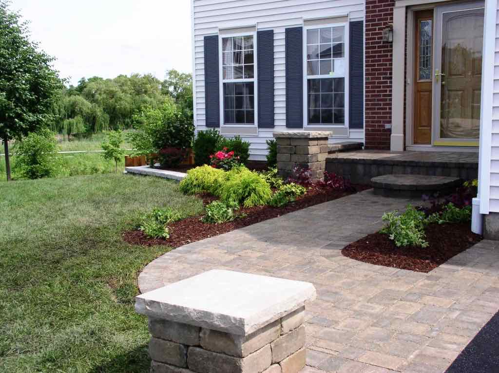 Curved paver walkway leading to a home's front entrance